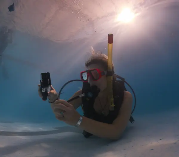 Alumno haciendo el curso de fotografía en pileta y fotografiando objetos